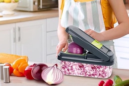 Woman using vegetable chopper. B0DJL1DNM3