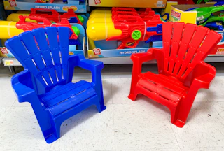 blue and red kids adirondack plastic chairs on floor at walmart in front of super soaker toys