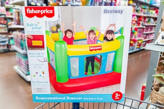 Fisher-price indooor bouncer on edge of Walmart shopping cart