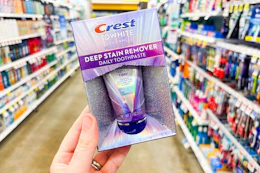 hand holding crest toothpaste