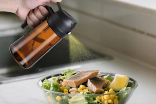 an oil sprayer on a salad