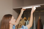 a woman using closet lights