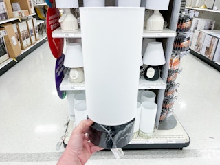 hand holding a black and white faux marbled mini lamp