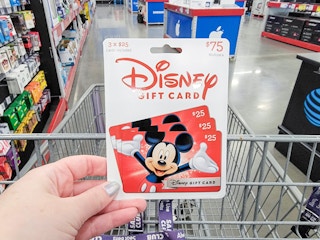 hand holding a disney gift card
