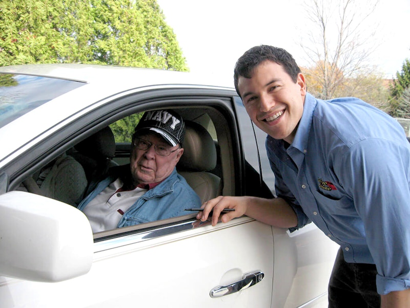 veteran in car next to car wash employee