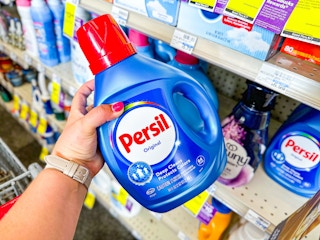 person grabbing persil detergent from a shelf