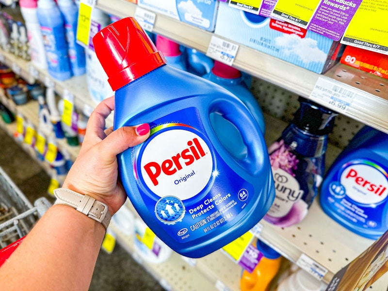 person grabbing persil detergent from a shelf
