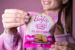 a teenage holding cooper street barbie cookies