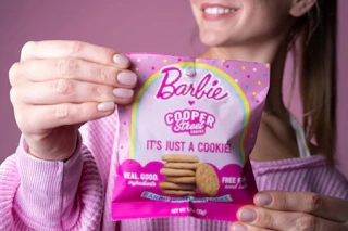 a teenage holding cooper street barbie cookies