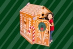 Stock photo of the Kidtopia Gingerbread Play House (door being opened up by a small child)
