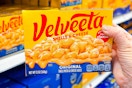 hand holding a box of velveeta shells and cheese