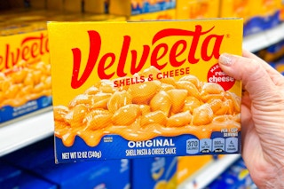 hand holding a box of velveeta shells and cheese