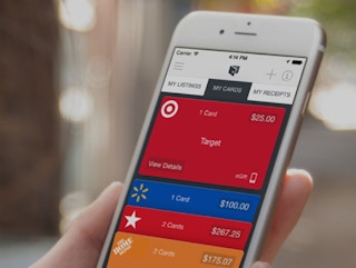 A person holding a cellphone in their hand with the Raise app open on the screen.