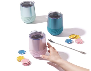 Three tumblers on a white table with poker chips