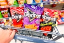 three bags of doritos in shopping cart in snack aisle at store