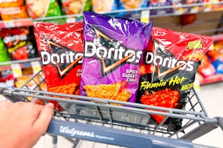 three bags of doritos in shopping cart in snack aisle at store