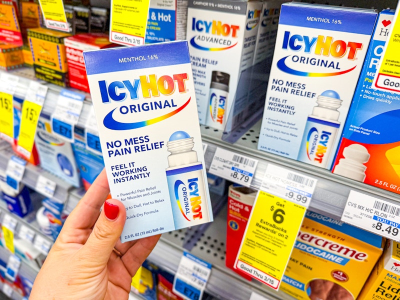 person holding icy hot pain relief by the display shelf