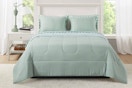 Lifestyle image of the Mainstays 7 piece bed in a bag comforter set in the color sage (bedroom setting)