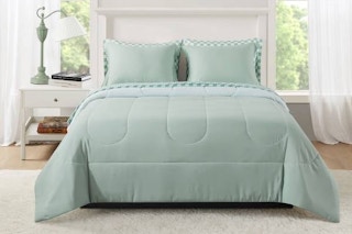Lifestyle image of the Mainstays 7 piece bed in a bag comforter set in the color sage (bedroom setting)