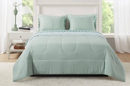Lifestyle image of the Mainstays 7 piece bed in a bag comforter set in the color sage (bedroom setting)