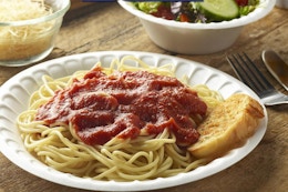 spaghetti on a foam plate on a table
