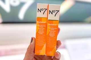 hand holding up two no7 eye creams