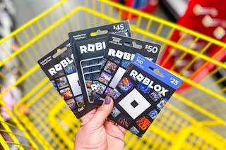 hand holding roblox gift cards