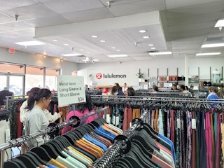 people shopping and checking out at lululemon outlet store