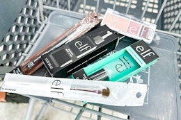 elf eyeshadow, setting spray, makeup brush, and more in a cart