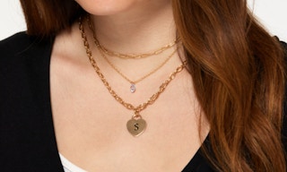 a woman wearing a 3-piece layered initial necklace