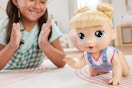 a girl playing with a baby alive doll