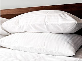 A set of Beckham Hotel Collection pillows on a bed.
