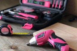 a pink tool kit next to a small pink drill 