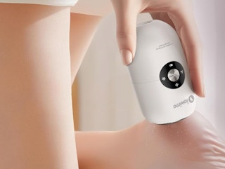 a person using an electric foot callus remover on their foot