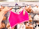 hand holding a hanger with a no boundaries bralette in the walmart bra aisle