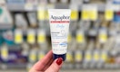 person holding baby aquaphor healing ointment
