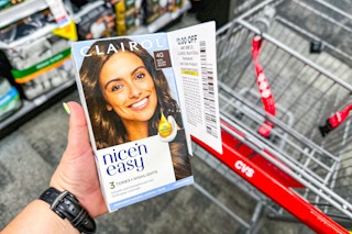 person holding clairol hair color over a cvs cart