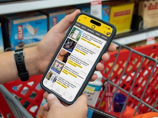 Someone looking at the KCL app on their phone while shopping in Target