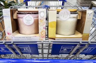 2 large candles in a shopping cart