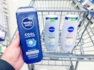 person holding mens nivea body wash over a cart with more nivea body wash in it