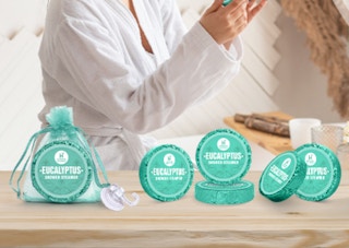 teal shower steamers on a wooden table 