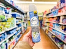 person holding glade air freshener in an aisle