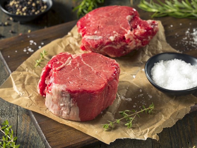 cuts of raw filet mignon steak on parchment