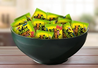 a bowl full of Sour Patch Kids Candy pouches