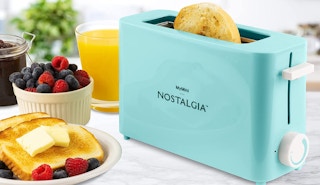 teal mini toaster on a table with food