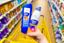 hand holding studio selection sunscreen at dollar general