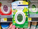 hand holding a febreze small spaces air freshener at dollar general