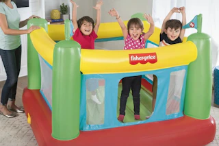 children jumping a Fisher-Price bounce house