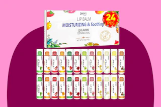 Twenty-four tubes of lip balm are lined up in two rows and the box they came in is above them