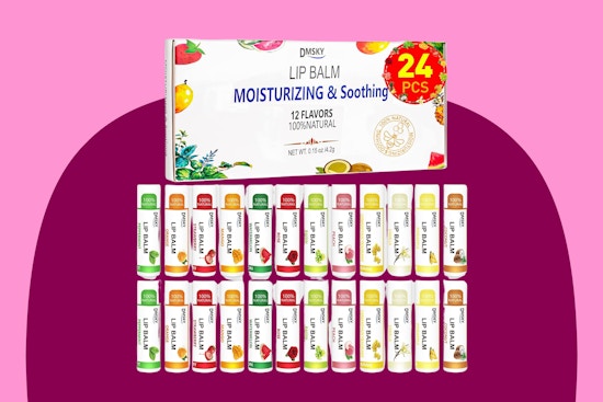 Twenty-four tubes of lip balm are lined up in two rows and the box they came in is above them
